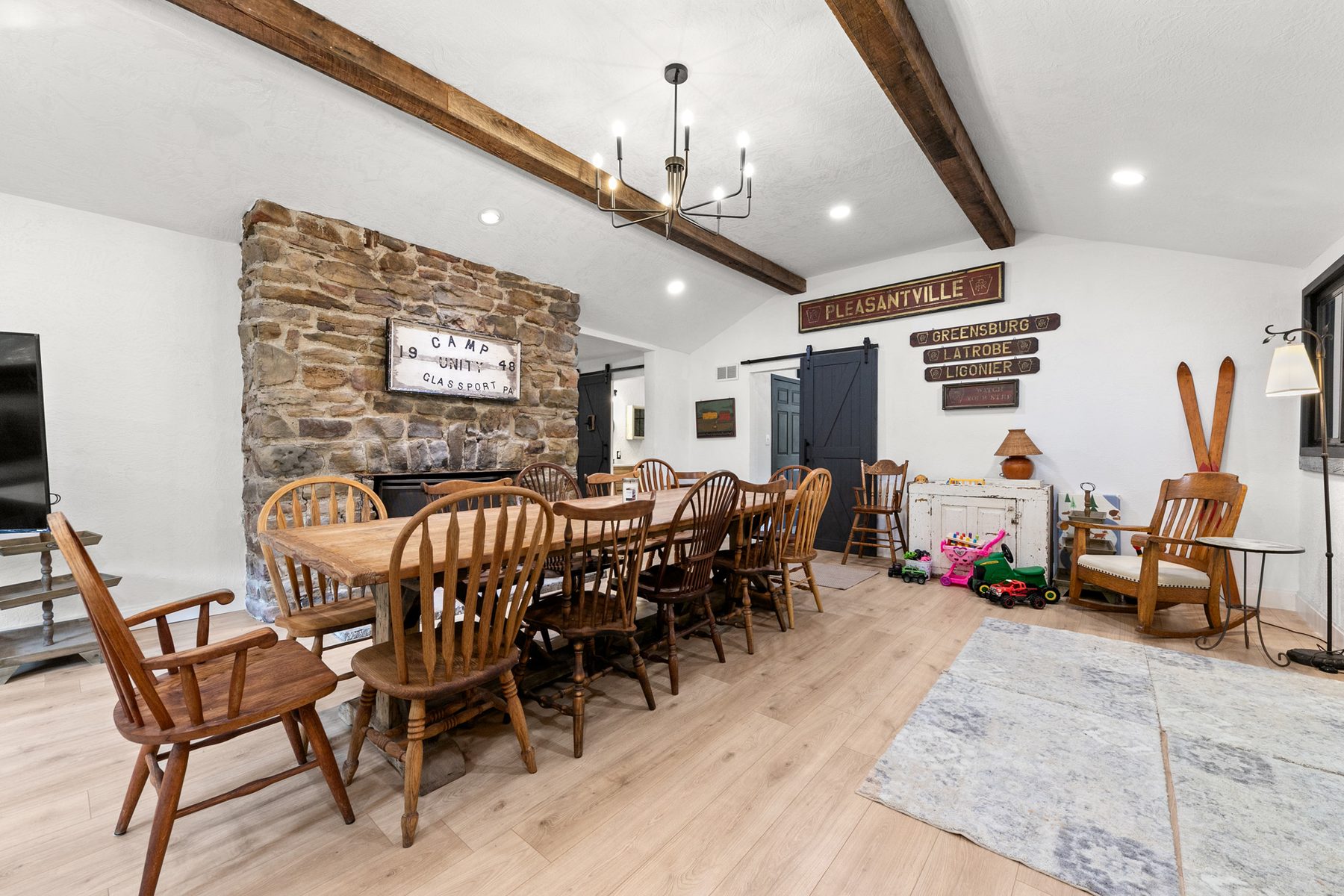 Great room with stone fireplace and long antique dining table
