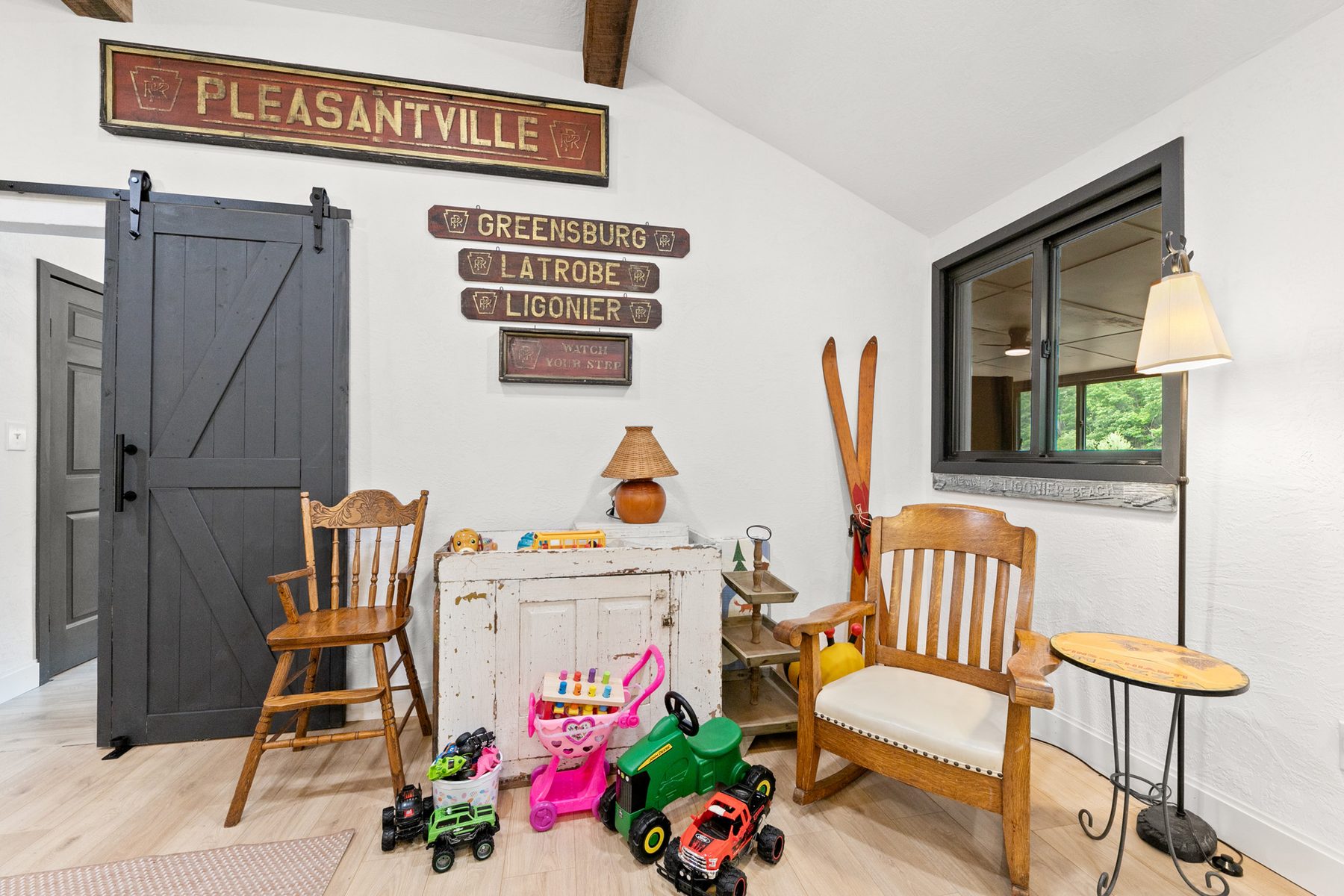 Kids' play corner inside the cabin with vintage signs and toys