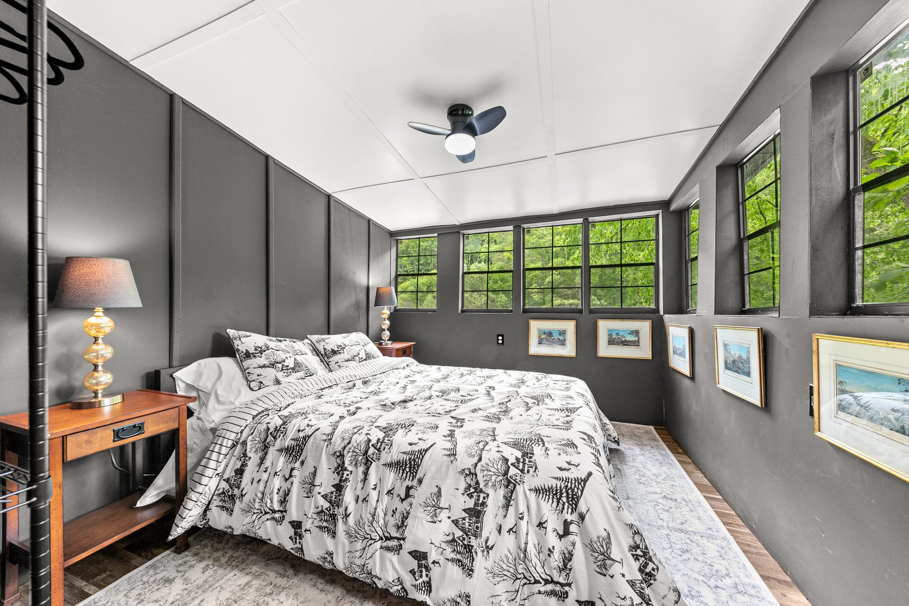 Primary bedroom with forest-view windows