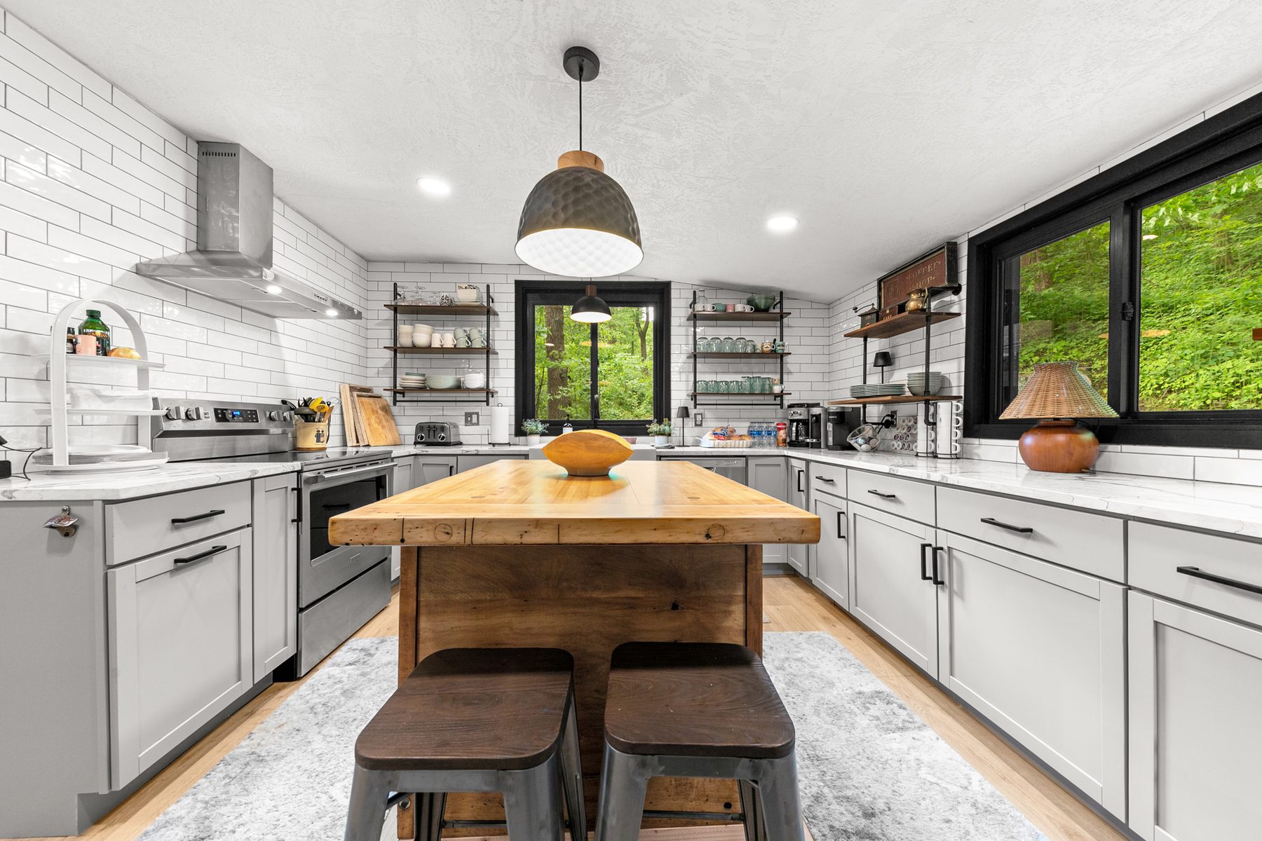 Modern kitchen with butcher-block island and subway tile